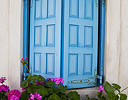 Window Shutter in Blue and Geraniums in bloom, Mykonos Greek Isles